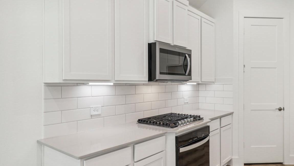 kitchen with stainless steel appliances and quartz countertops