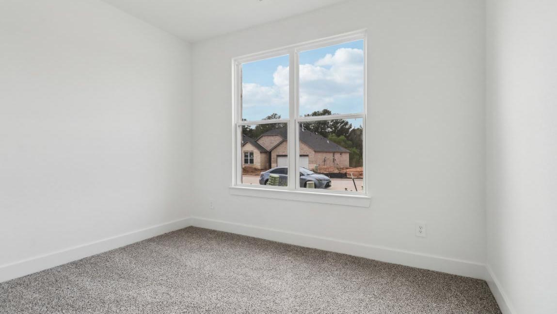 bedroom with carpet flooring and windows