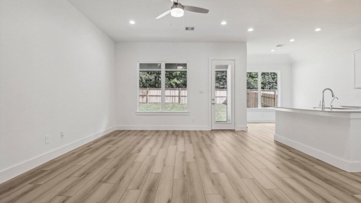 open concept living and dining area with large windows
