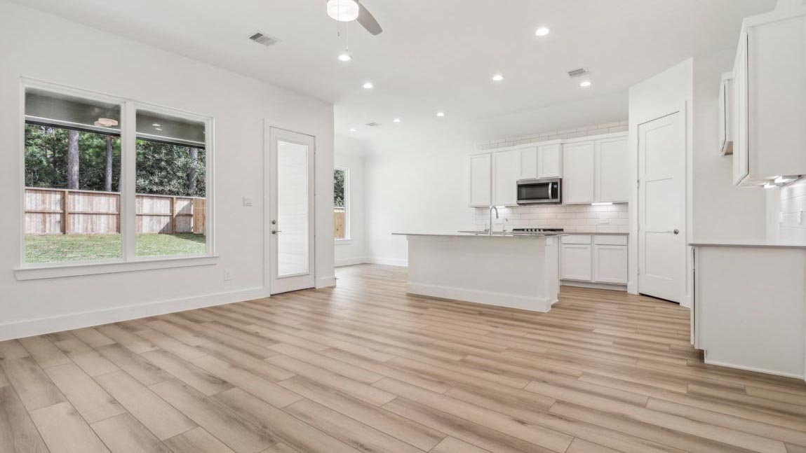 open concept living and dining area with large windows