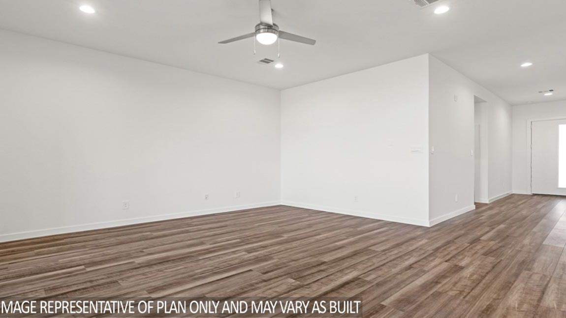 Spacious living area with vinyl flooring