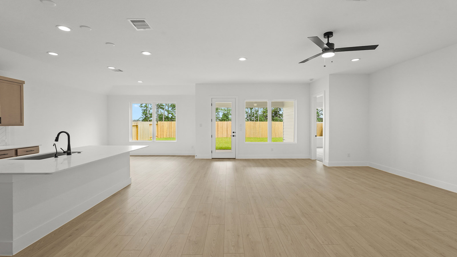 Kitchen with quartz countertops and marden hardware and an island and vinyl floor