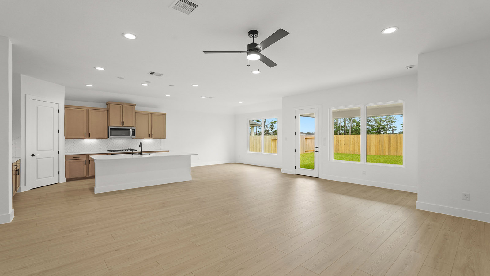 Kitchen with quartz countertops and marden hardware and an island and vinyl floor