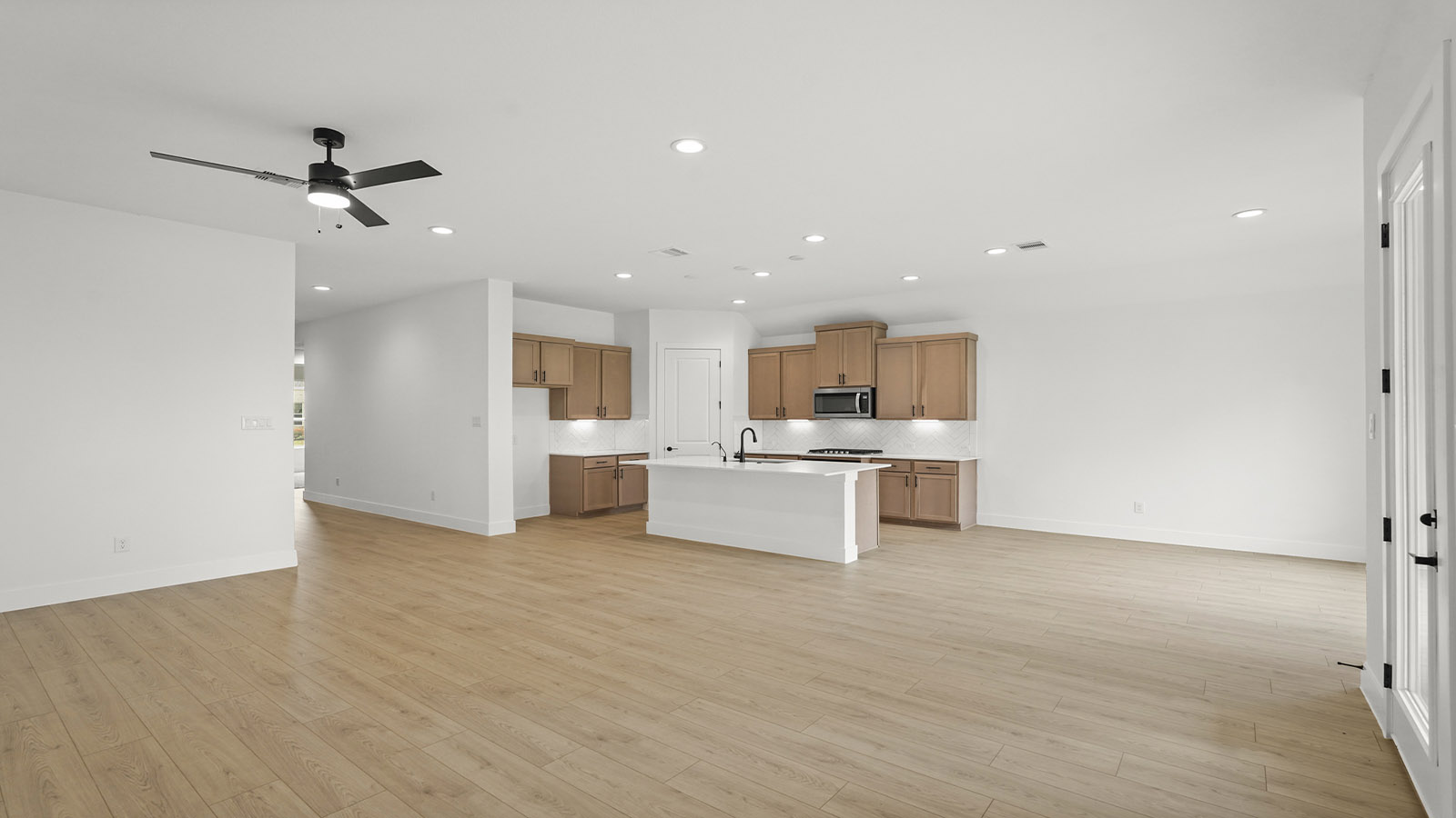 Kitchen with quartz countertops and marden hardware and an island and vinyl floor