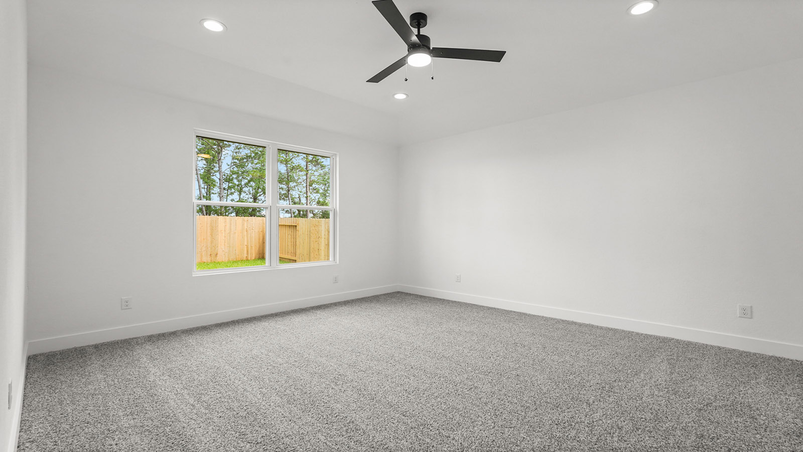 Large Primary bedroom with shag carpet flooring and bright window