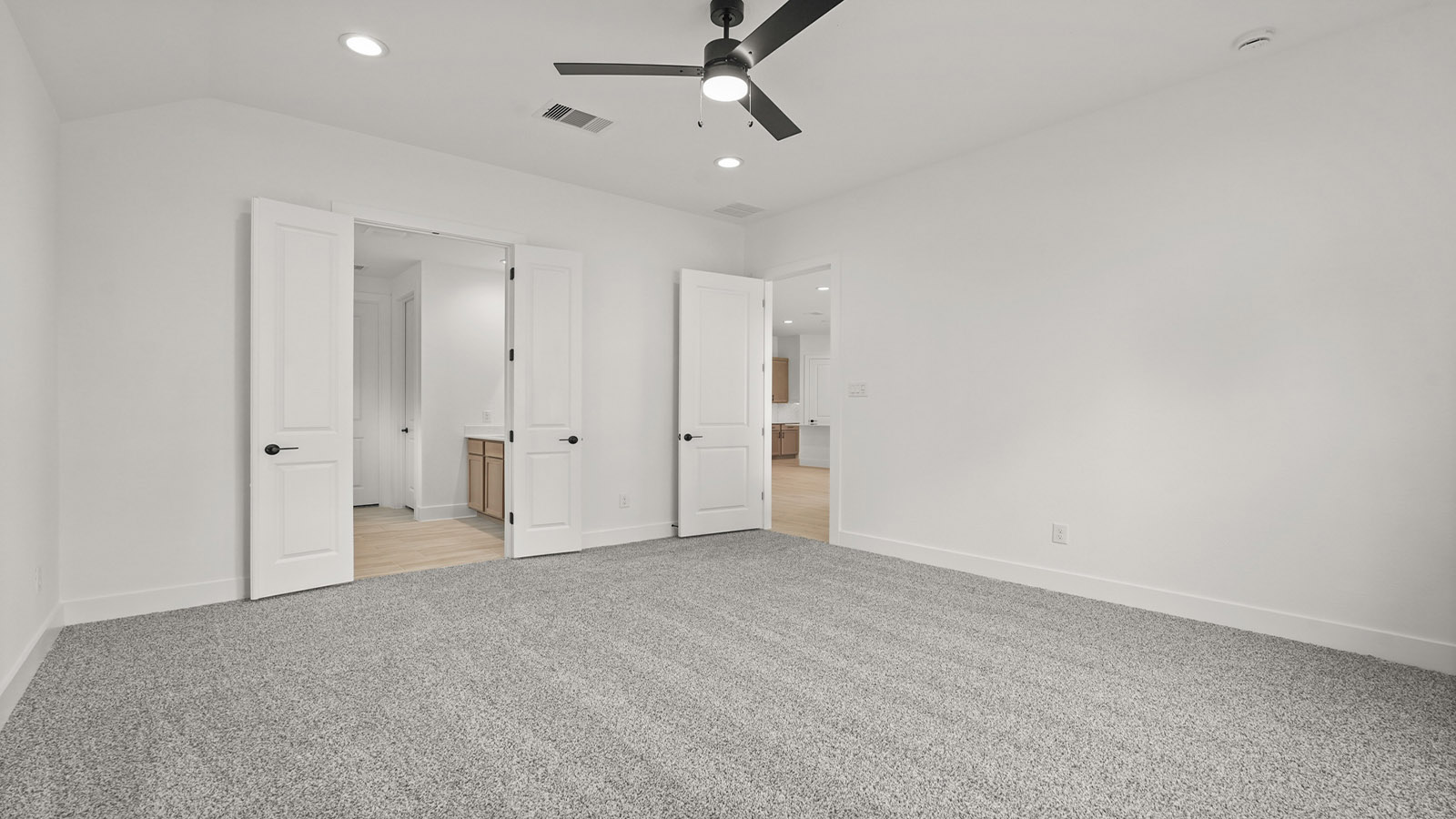 Large Primary bedroom with shag carpet flooring and bright window