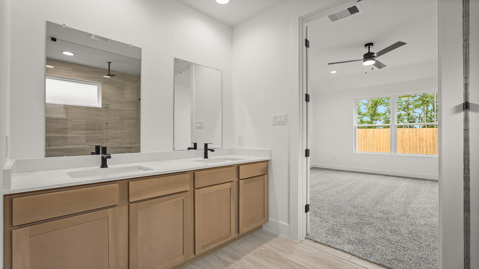 Primary bathroom with double sinks with quartz counter tops in Magnolia TX