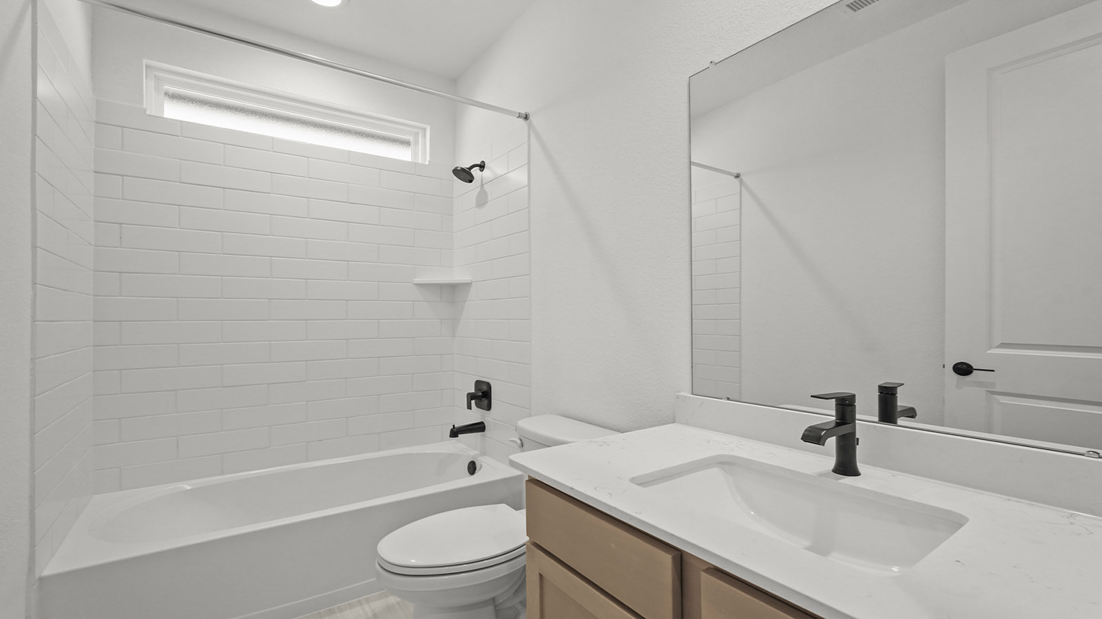 Secondary bathroom with tub/shower combo with quartz counter tops in Magnolia TX