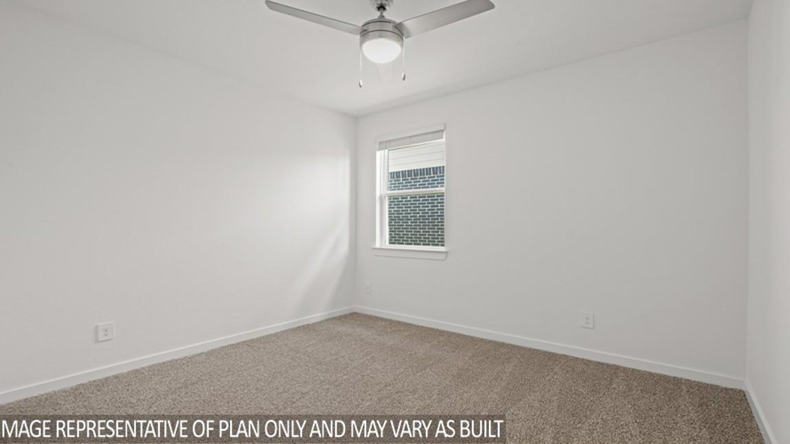 Secondary bedroom with shag carpet flooring and bright window