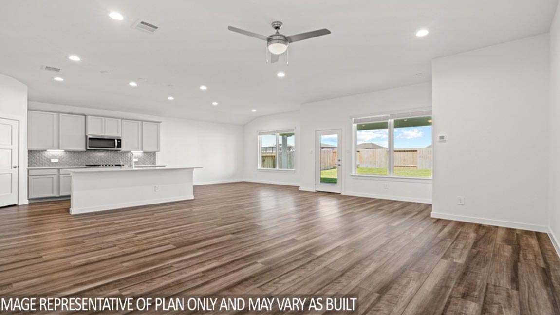Kitchen with quartz countertops and marden hardware and an island and vinyl floor