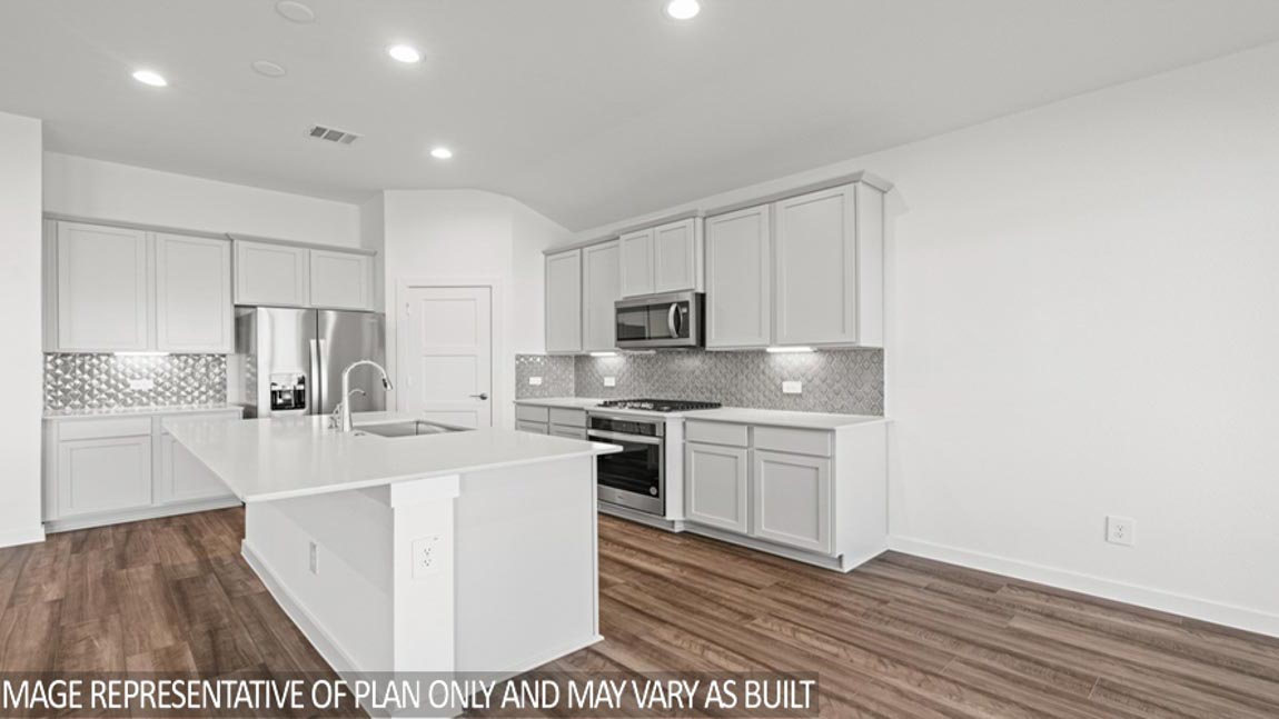 Kitchen with quartz countertops and marden hardware and an island and vinyl floor