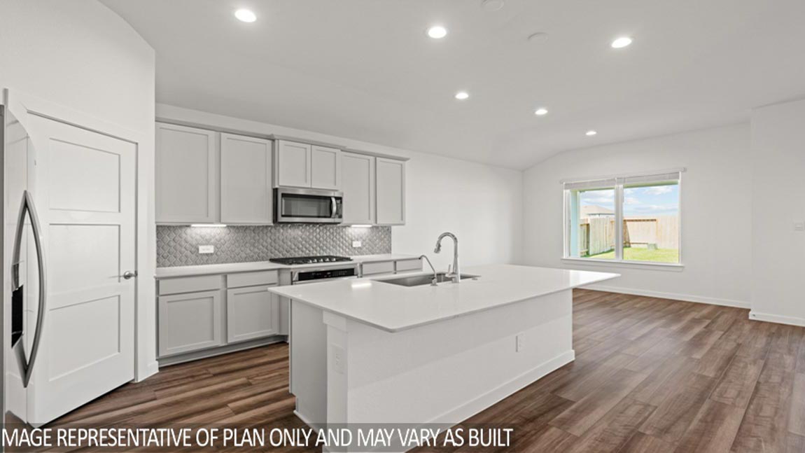 Kitchen with quartz countertops and marden hardware and an island and vinyl floor
