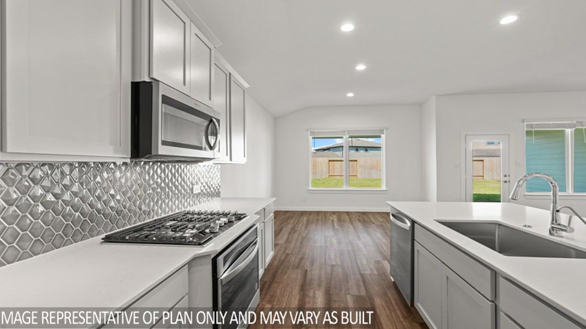 Kitchen with quartz countertops and marden hardware and an island and vinyl floor