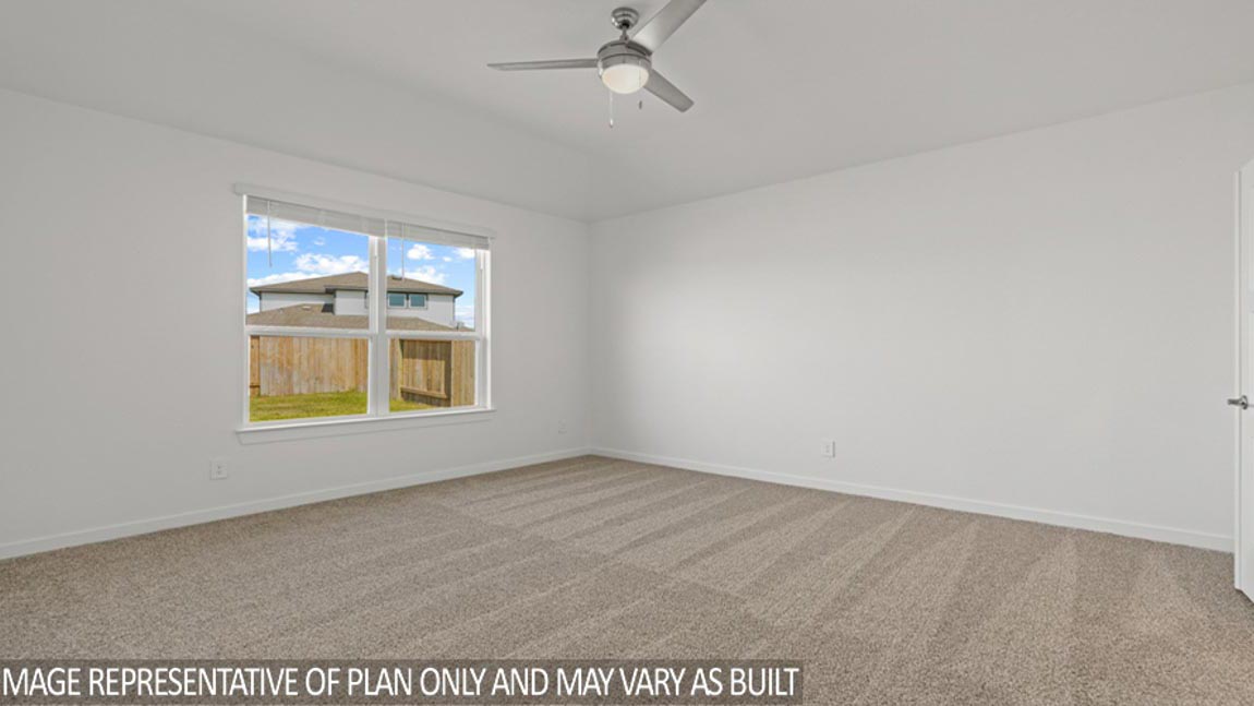 Secondary bedroom with shag carpet flooring and bright window