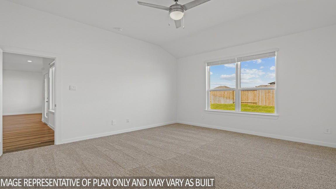 Large Primary bedroom with shag carpet flooring and bright window