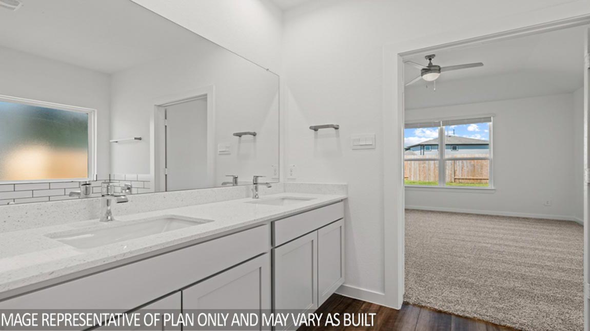 Primary bathroom with double sinks with quartz counter tops in Magnolia TX