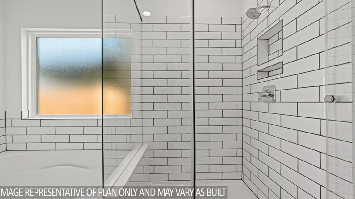Primary bathroom with stand-alone shower with tiles and semi frameless glass in Magnolia TX