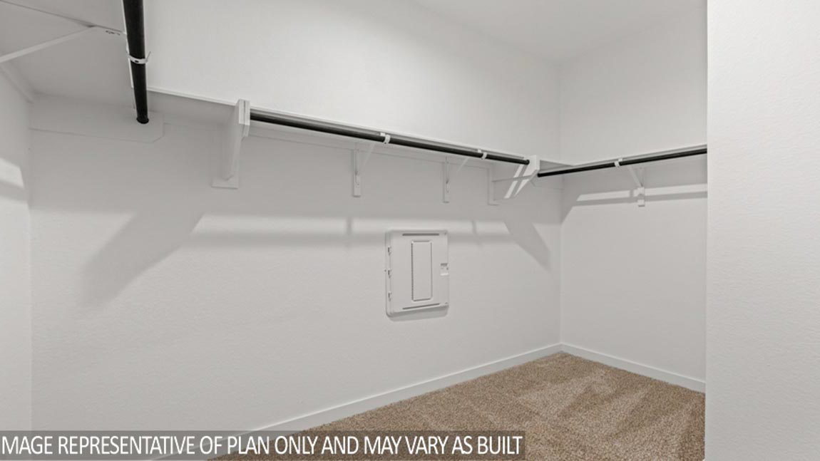 Primary bedroom walk-in closet with carpet flooring in Mill Creek community in Magnolia TX