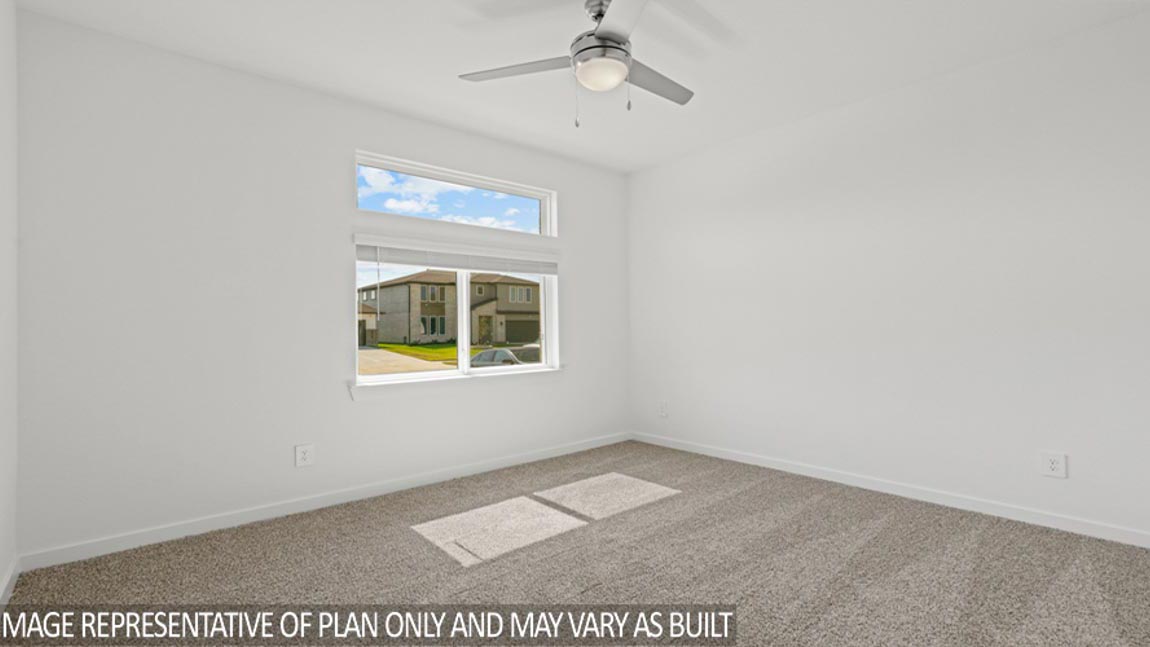 Secondary bedroom with shag carpet flooring and bright window