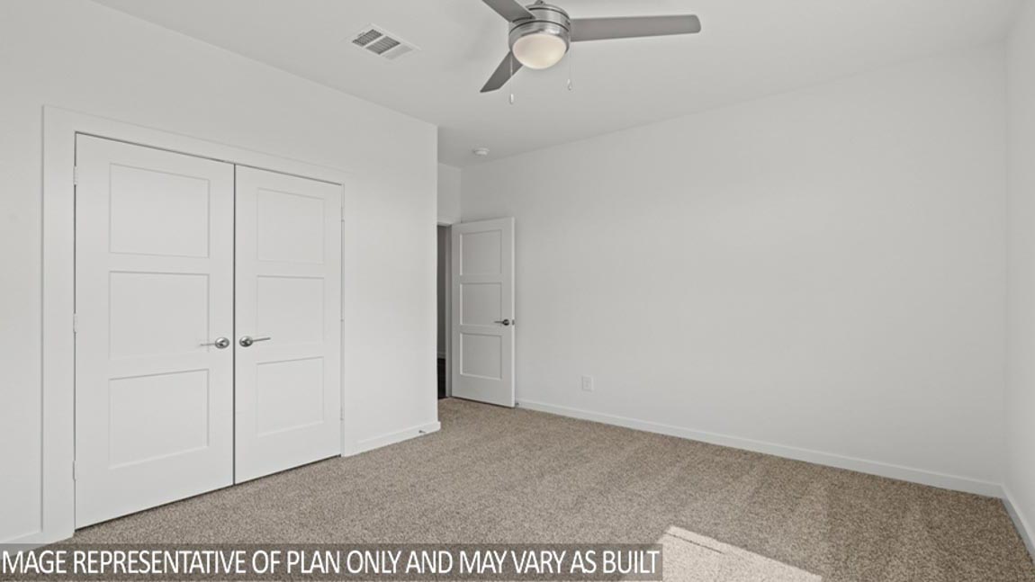 Secondary bedroom with shag carpet flooring and bright window
