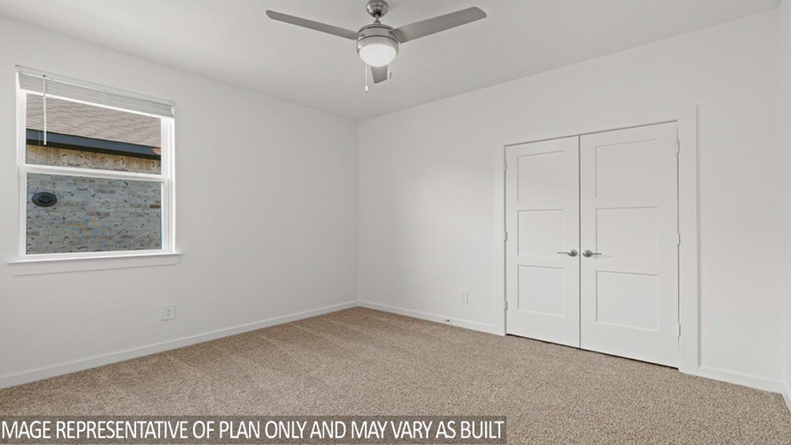 Secondary bedroom with shag carpet flooring and bright window