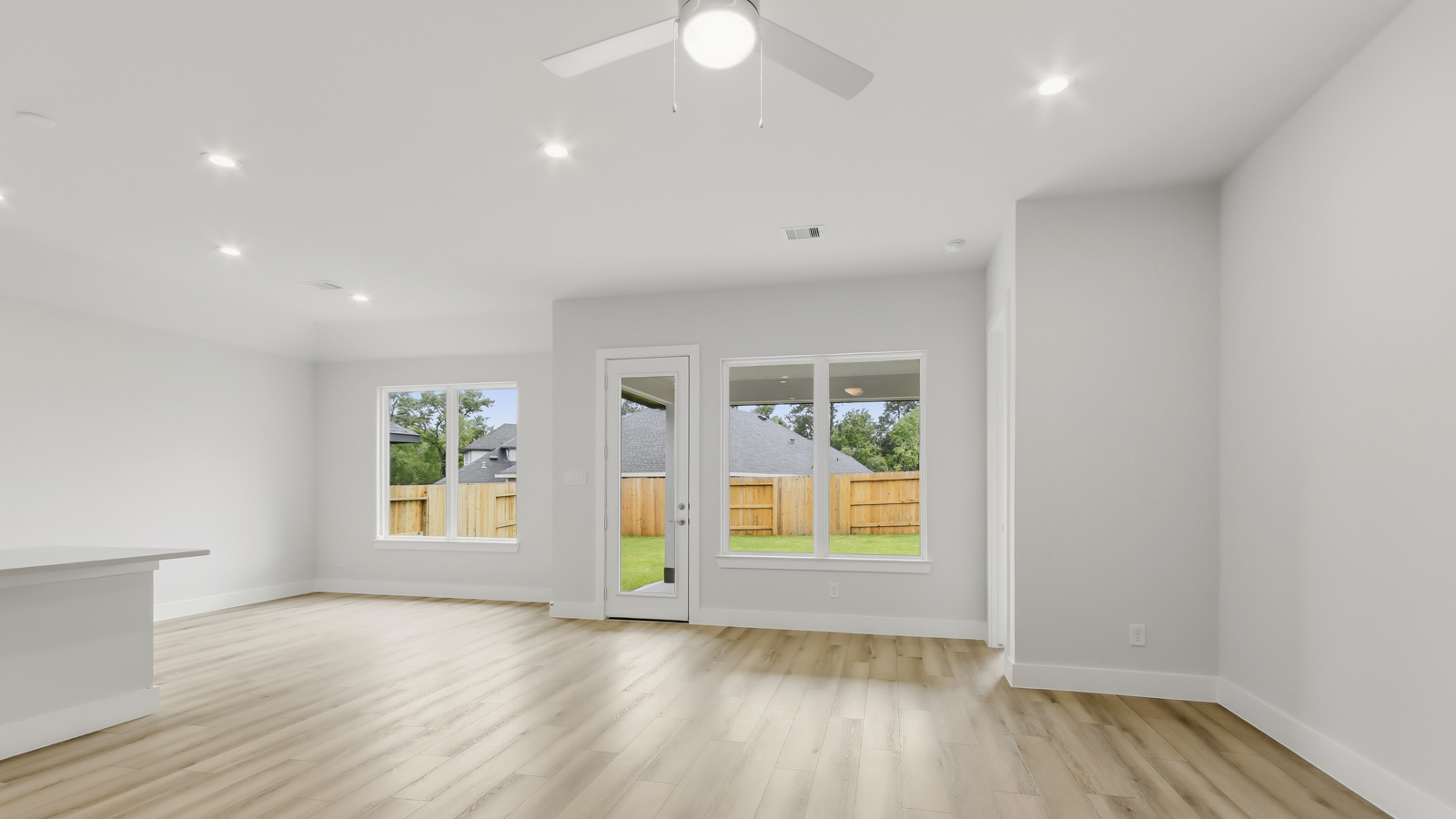 Spacious living area with vinyl flooring and bright windows in Montgomery TX