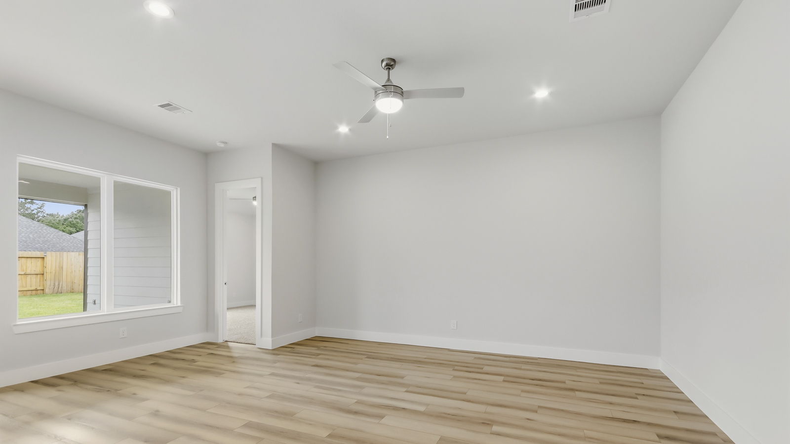 Spacious living area with vinyl flooring and bright windows in Montgomery TX