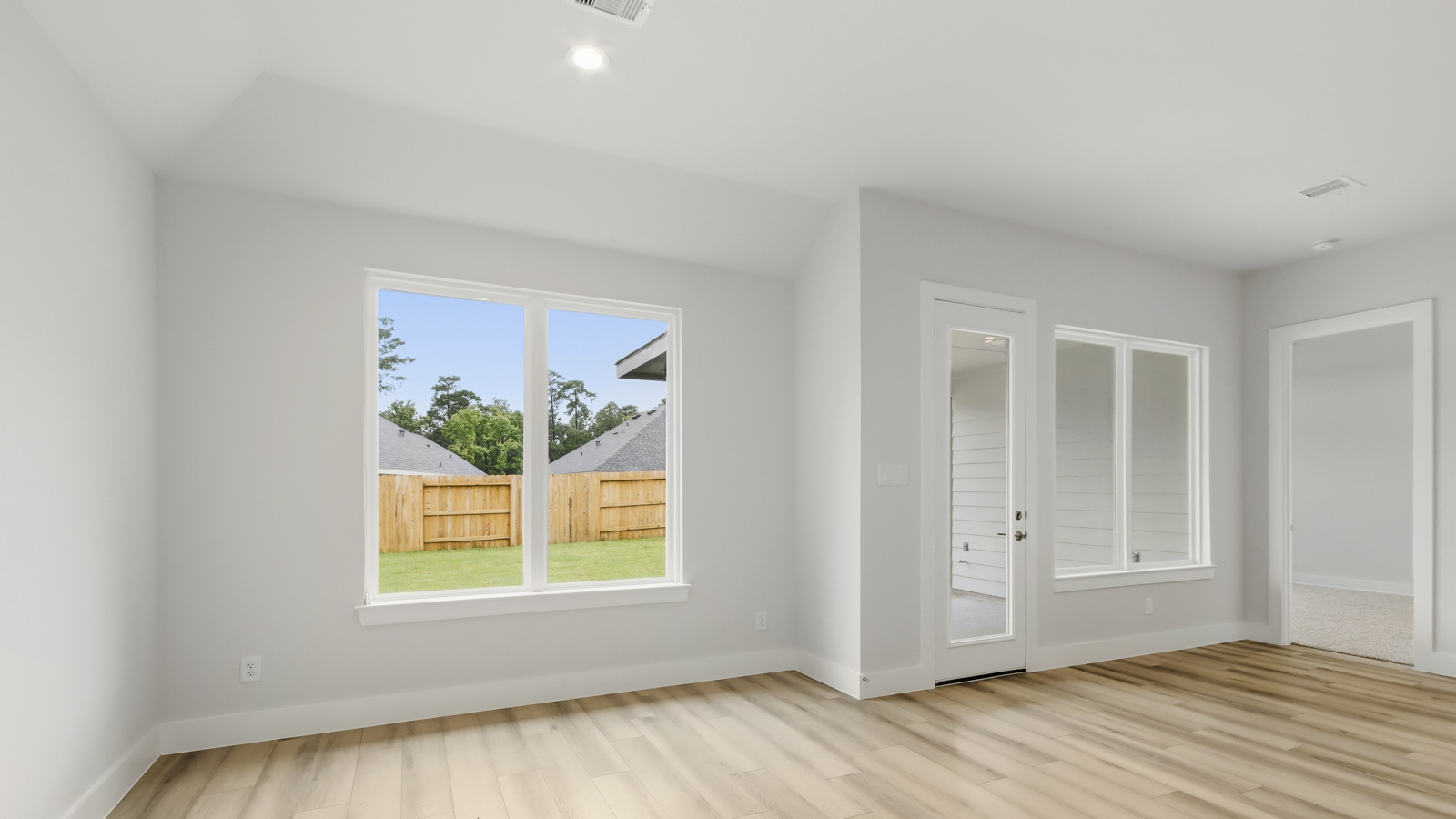 Spacious living area with vinyl flooring and bright windows in Montgomery TX