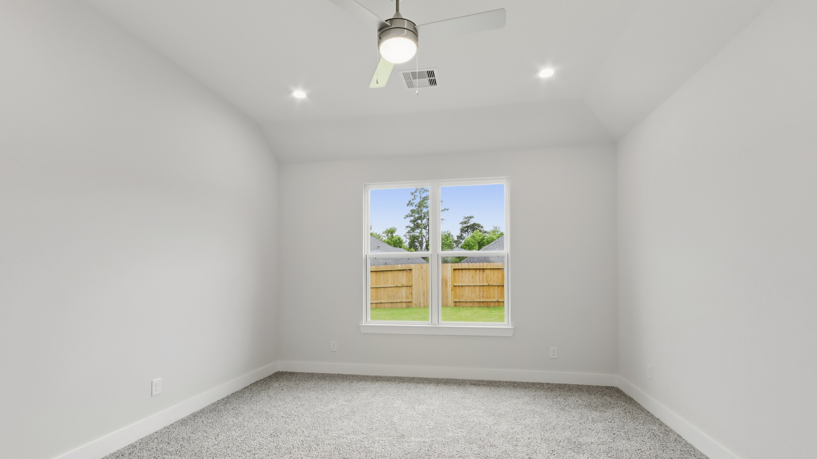 Secondary bedroom with shag carpet flooring and bright window
