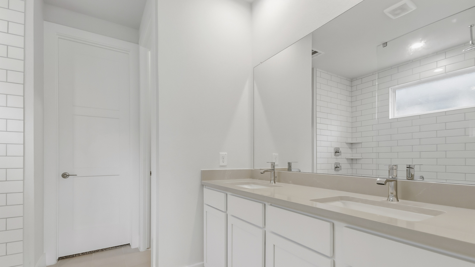 Primary bathroom with double sinks with quartz counter tops in Magnolia TX