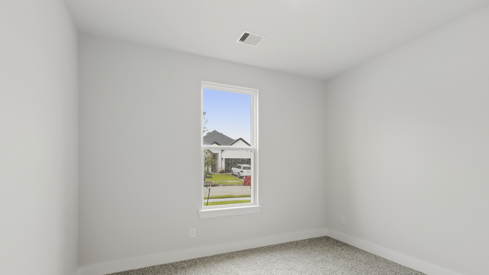Secondary bedroom with shag carpet flooring and bright window