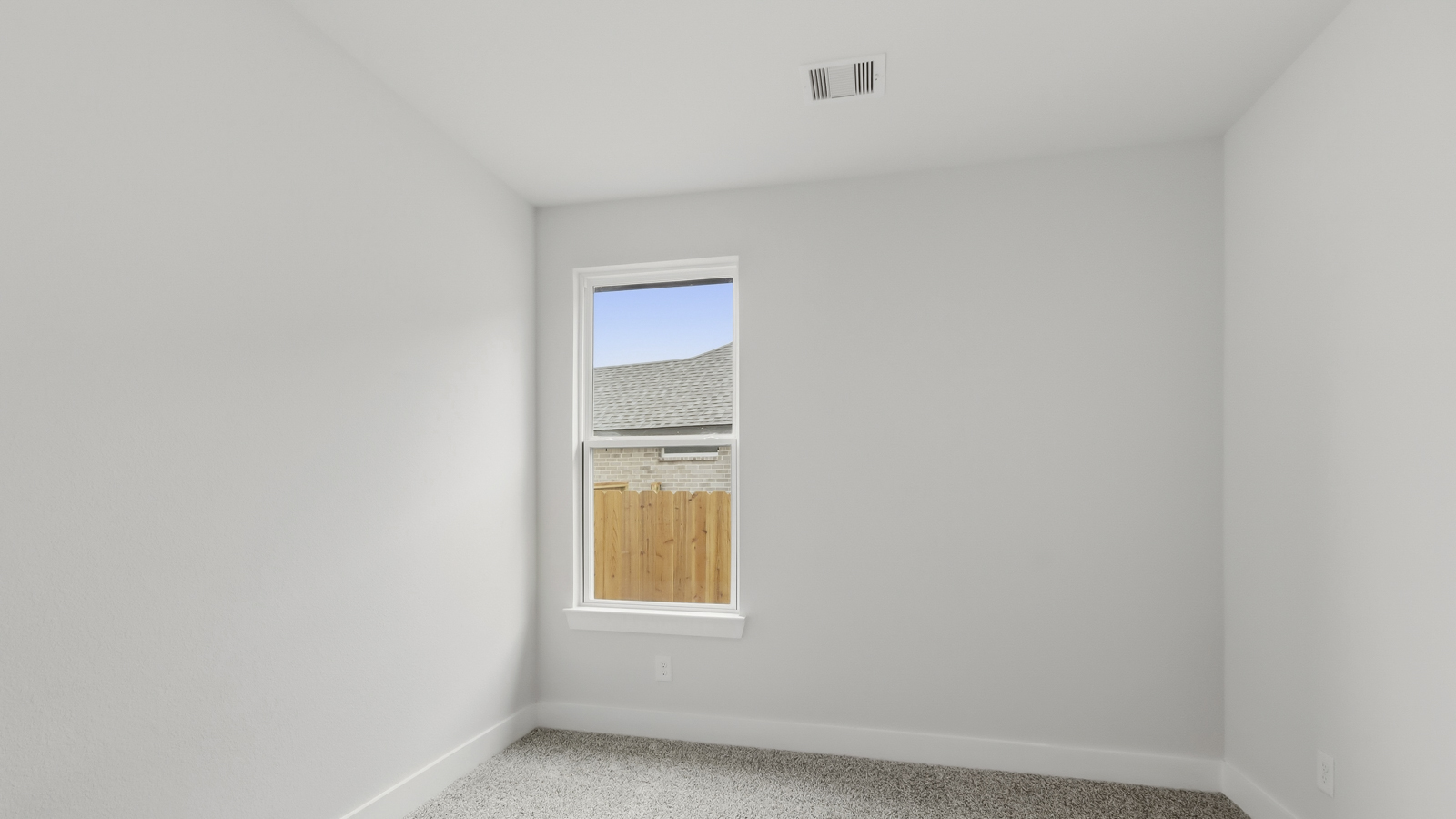 Secondary bedroom with shag carpet flooring and bright window
