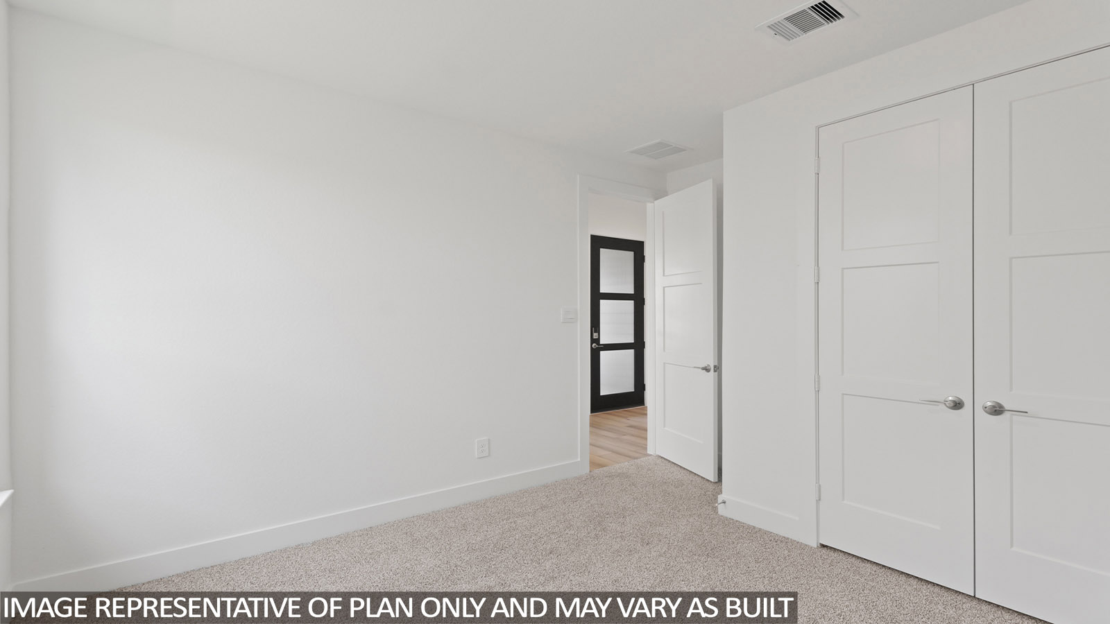 Secondary bedroom with carpet flooring