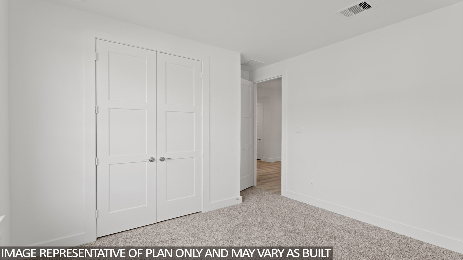 Secondary bedroom with carpet flooring