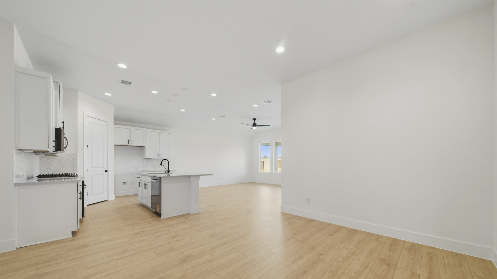 Spacious living area with vinyl flooring and bright windows in Magnolia TX