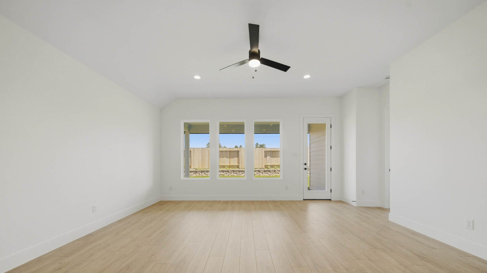 Spacious living area with vinyl flooring and bright windows in Magnolia TX