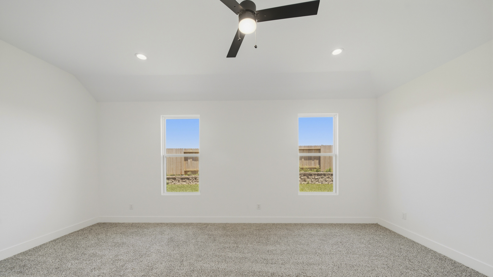 Large Primary bedroom with shag carpet flooring and bright window