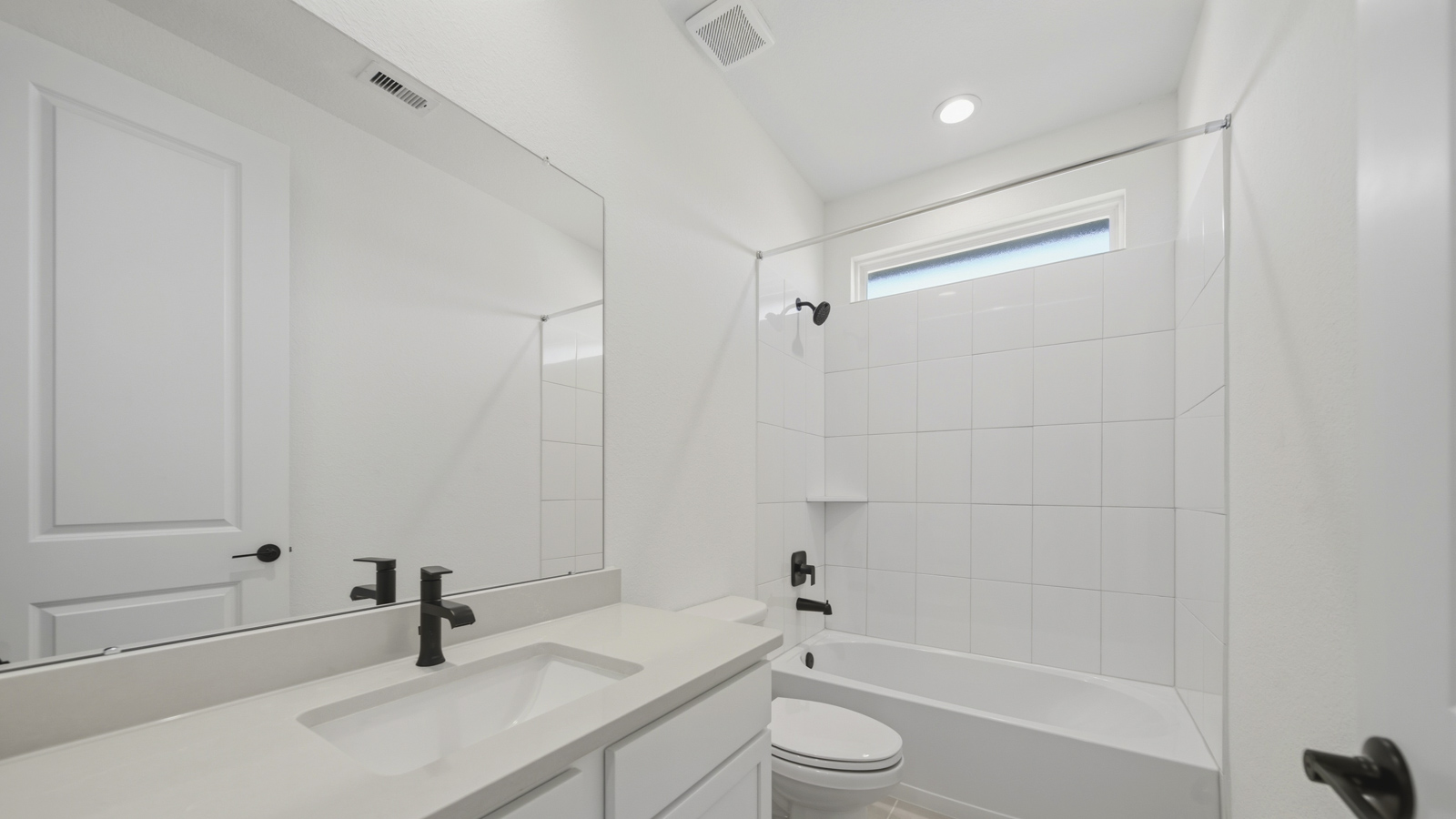 Secondary bathroom with tub/shower combo with quartz counter tops in Magnolia TX
