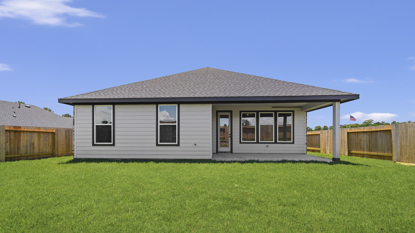 covered patio with jamies hardie siding and overhead lighting