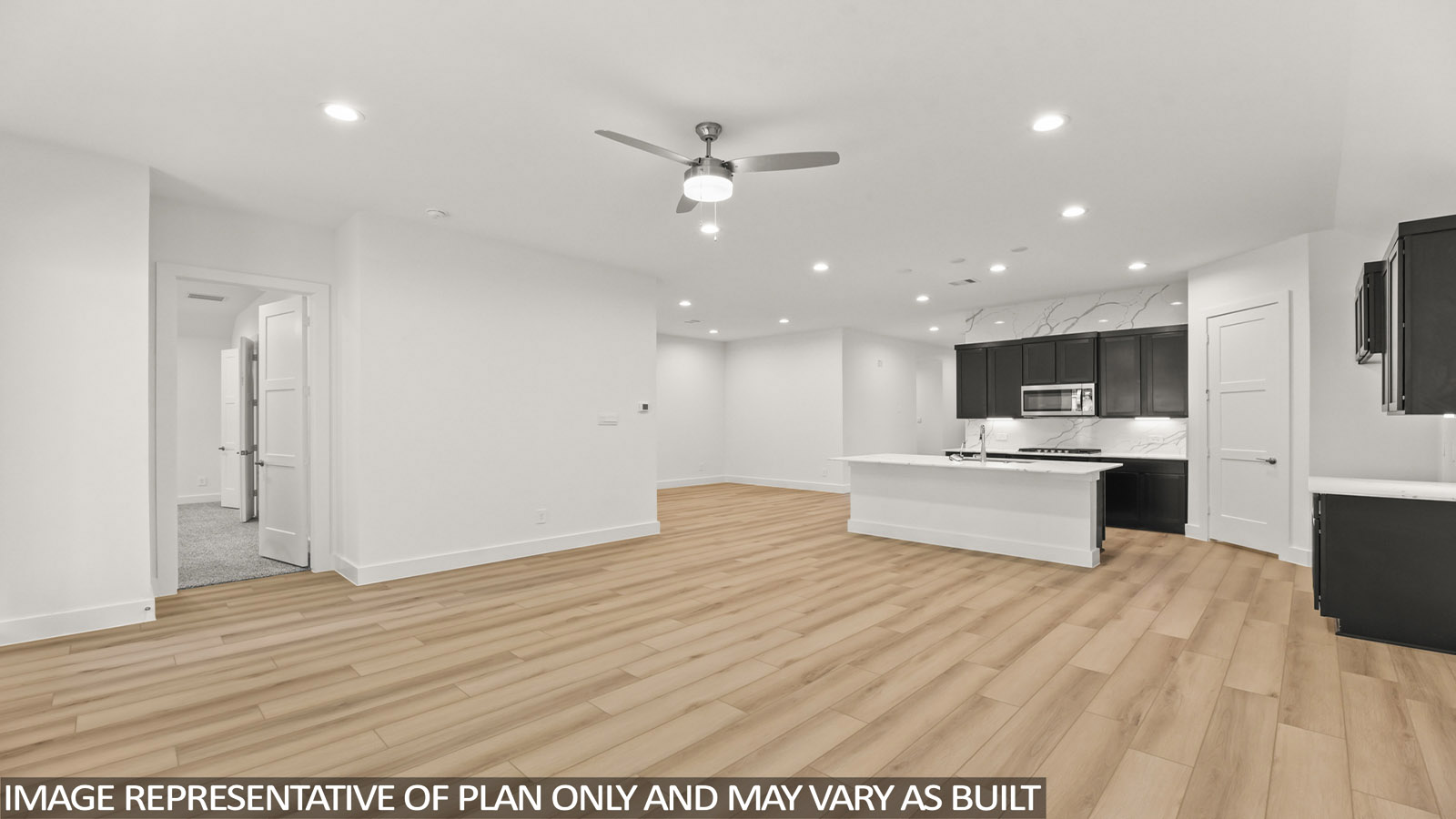 open concept living area with vinyl flooring and large windows