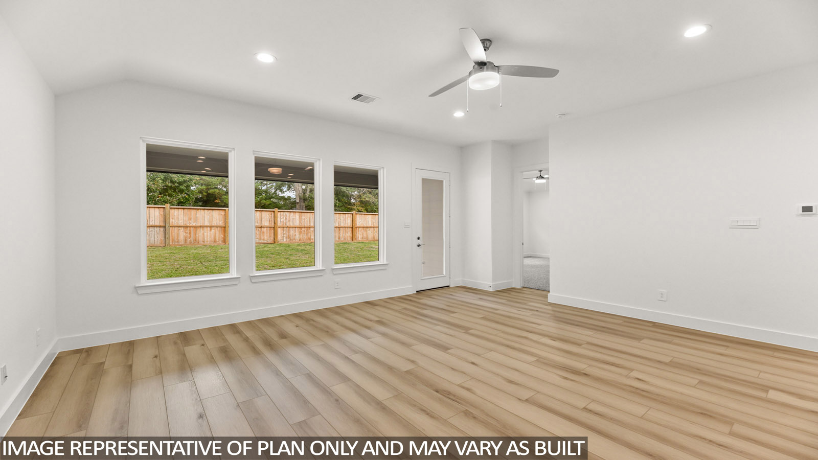 open concept living area with vinyl flooring and large windows