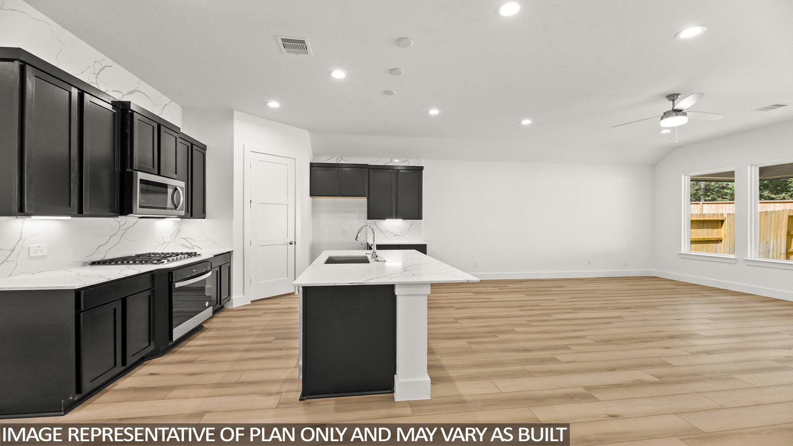 open concept living area with vinyl flooring and large windows