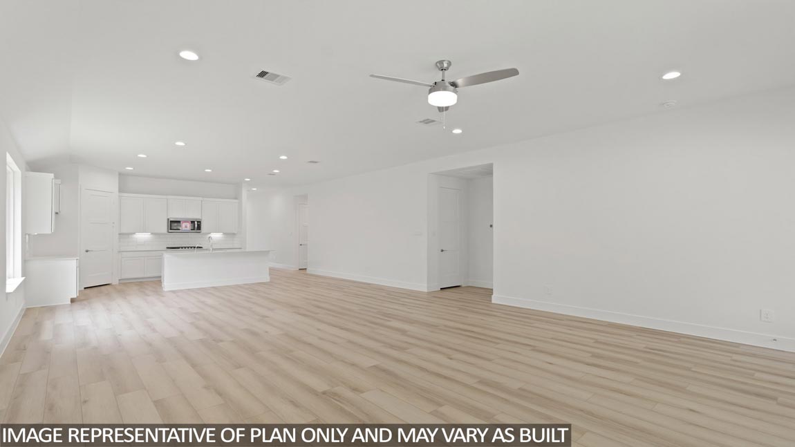 Spacious living area with vinyl flooring