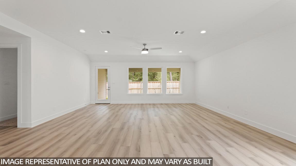 Spacious living area with vinyl flooring