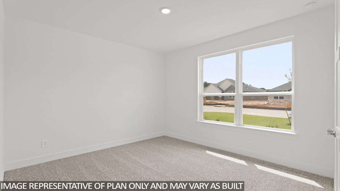 Secondary bedroom with carpet flooring