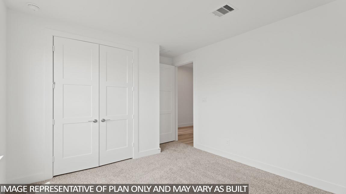Secondary bedroom with carpet flooring