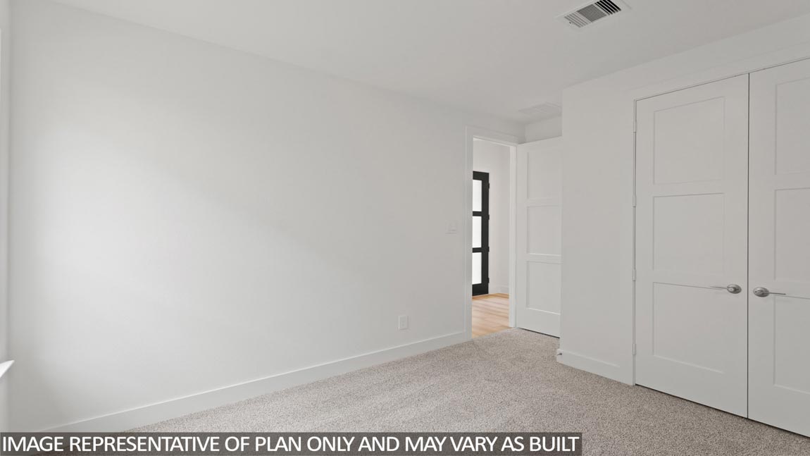Secondary bedroom with carpet flooring