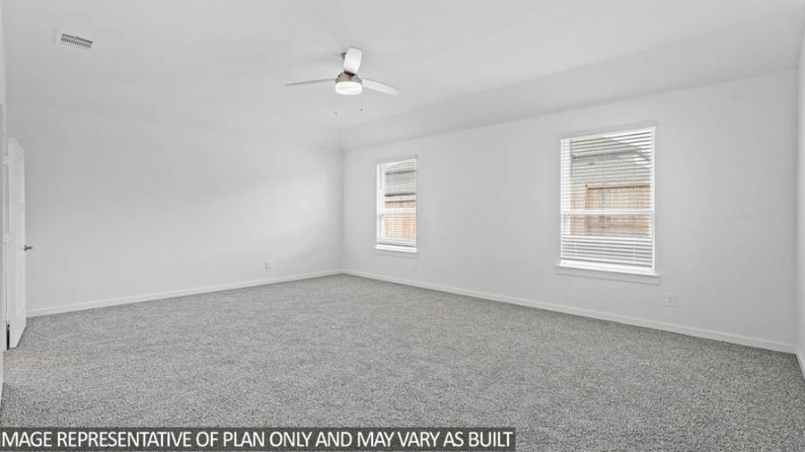 Primary bedroom with carpet flooring