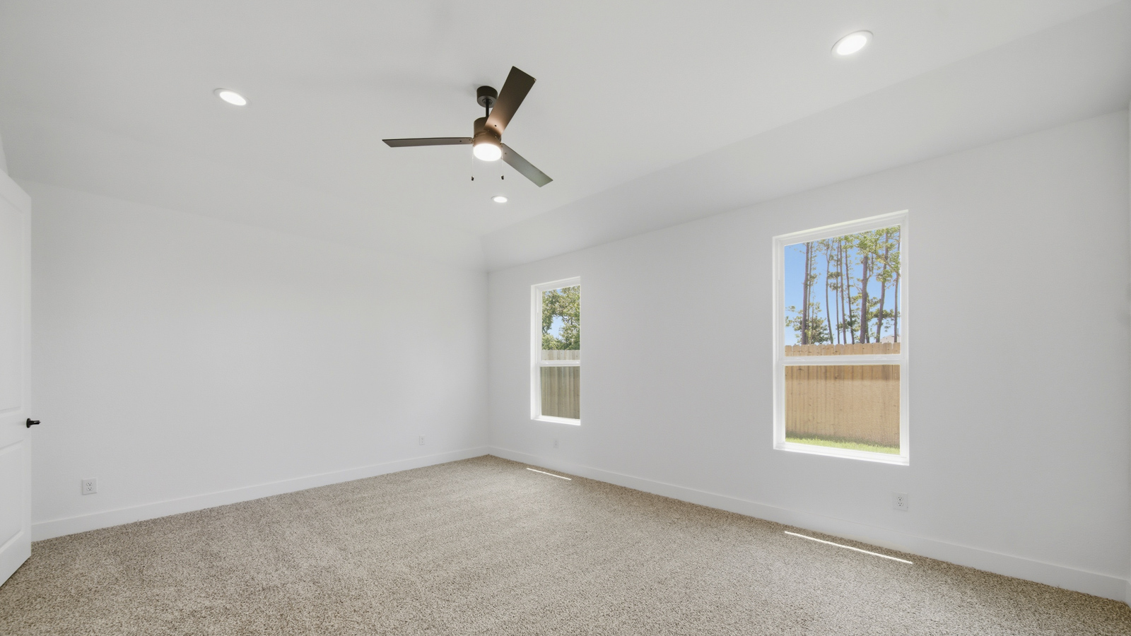 Large Primary bedroom with shag carpet flooring and bright window