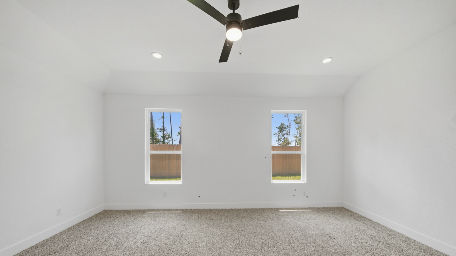 Large Primary bedroom with shag carpet flooring and bright window